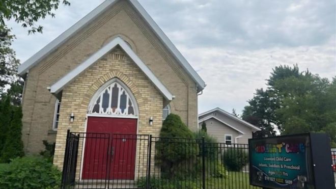 Image of a yellow brick church. 