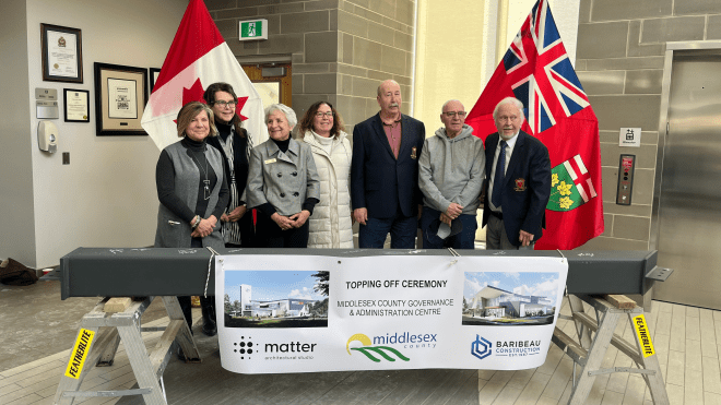 Image of members of County Council members posing with structural beam