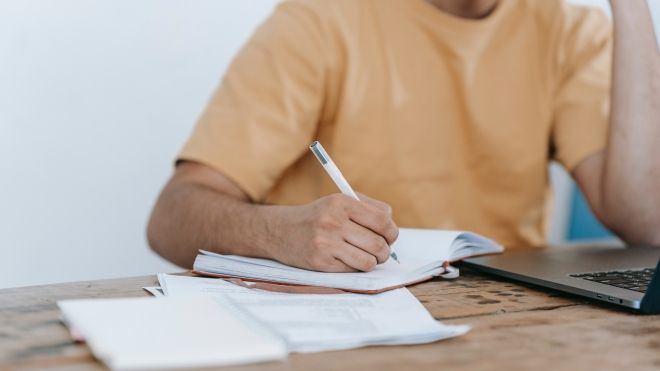 Man writing on paper 