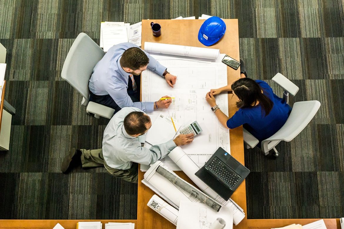 Three people sitting around a table