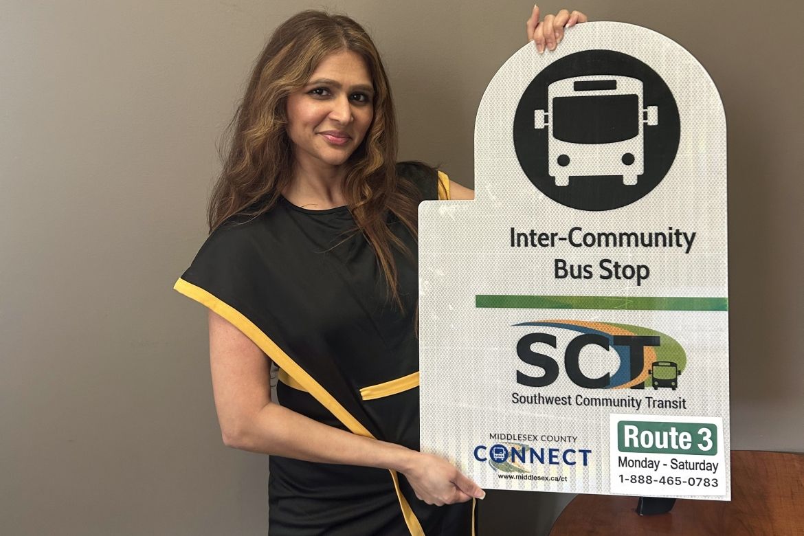 Anum Maqsood with inter community transit sign showing route 3