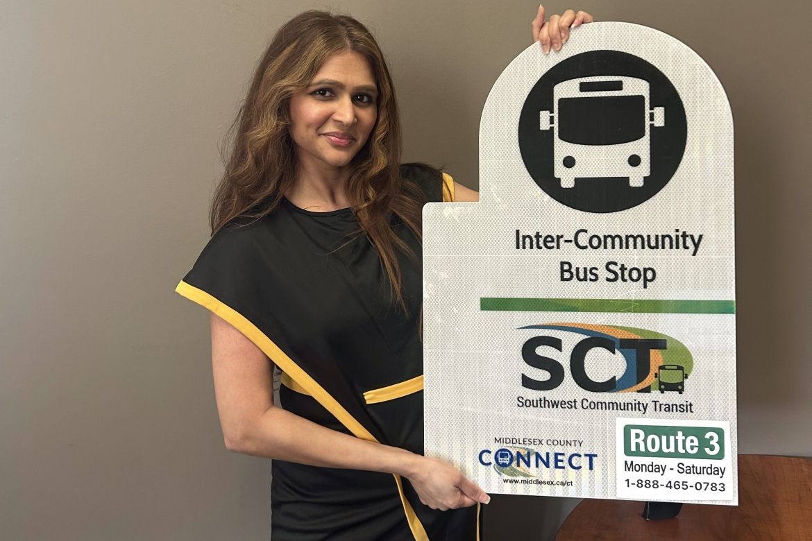 Anum Maqsood with inter community transit sign showing route 3