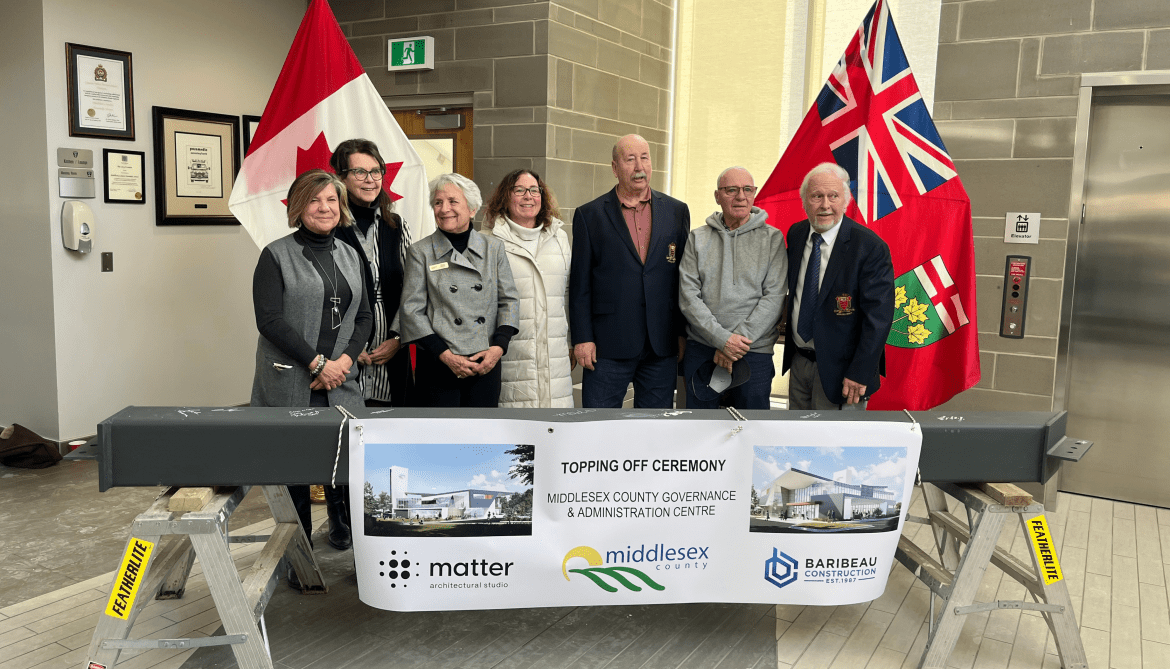 Image of members of County Council members posing with structural beam