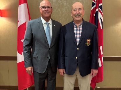 Image of Warden Brian Ropp standing next to Minister Rob Flack