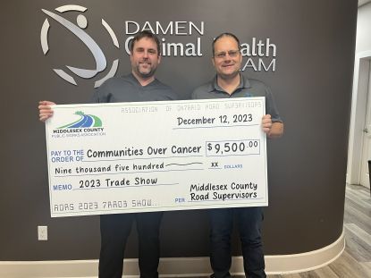 Communities Over Cancer presented with a cheque 