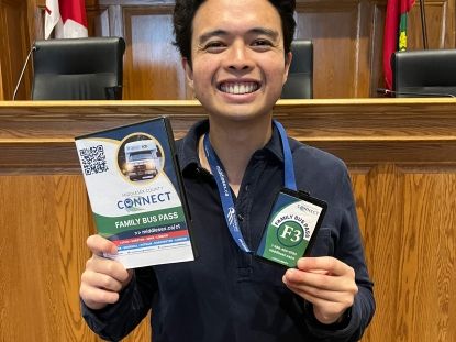 Man holding library bus passes