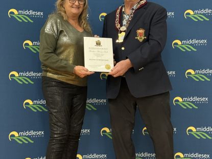 Image of Joanne Vanderheyden accepting award from Warden Brian Ropp