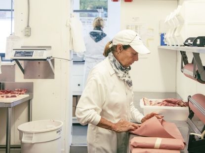 Woman cutting meat 